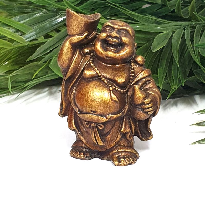 Happy Buddha statuette holding a gold ingot, symbolizing prosperity and joy, perfect for home decor and Feng Shui.