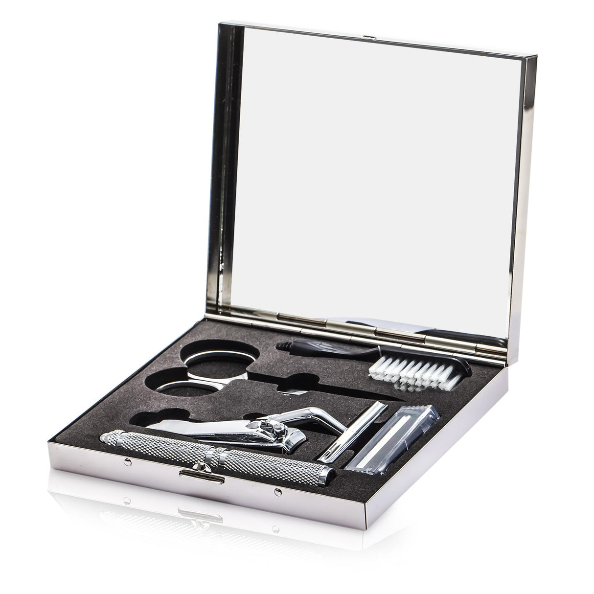 Grooming kit featuring a razor, scissors, nail clipper, and brush, elegantly packaged for men’s daily grooming needs.