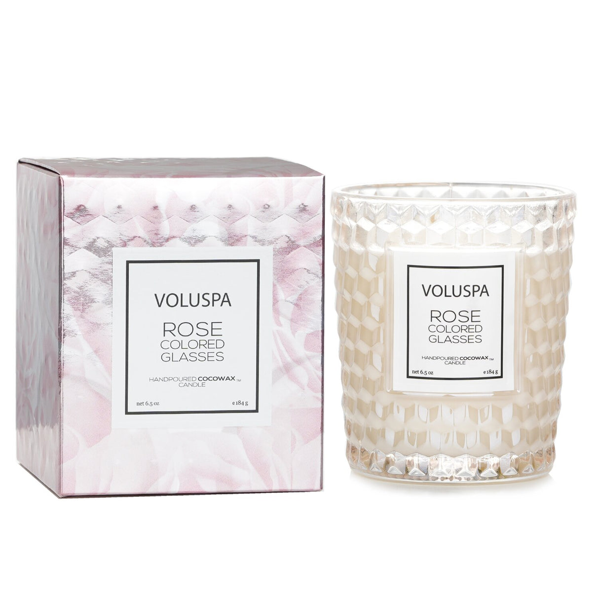 Elegant Voluspa Classic Candle in rose-colored glass, featuring a floral scent, coconut wax blend, and geometric design.