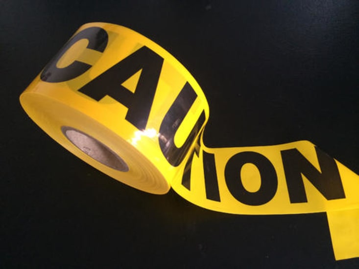 Bright yellow caution tape roll, 300m long and 100mm wide, designed for marking hazardous areas and promoting safety awareness.