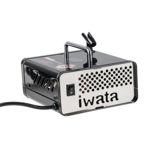 Compact Iwata Ninja Jet Compressor FIW163 with built-in airbrush holder, adjustable pressure, and protective metal cover.
