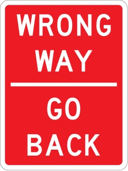 High-visibility aluminum directional sign warning of wrong-way driving, 900mm wide by 1200mm high, compliant with NZTA regulations.