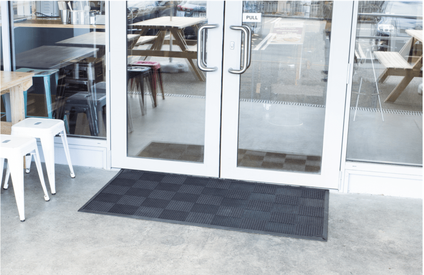 Durable black natural rubber scraper mat, 1500 x 900mm, with raised fins for effective dirt removal in high-traffic areas.