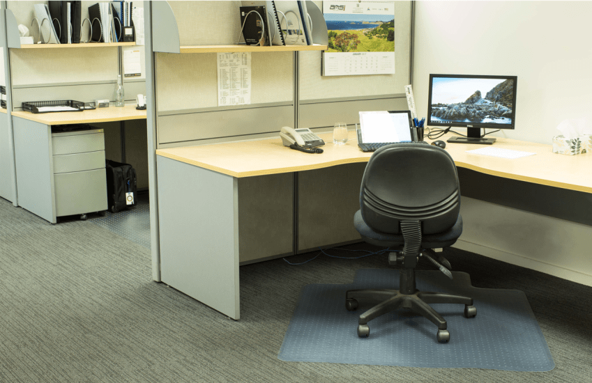 Clear heavy-duty chair mat (1350x1150mm) with cleated back for carpet, protecting floors and enhancing office mobility.