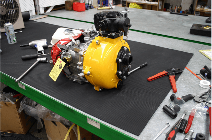 Durable black rubber flooring, 900mm wide, with fine rib texture for slip-resistance, ideal for workspaces and tool protection.