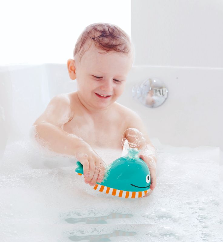 Colorful Hape Bubble Blowing Whale bath toy blowing bubbles, designed for imaginative play and sensory development for ages 2+.