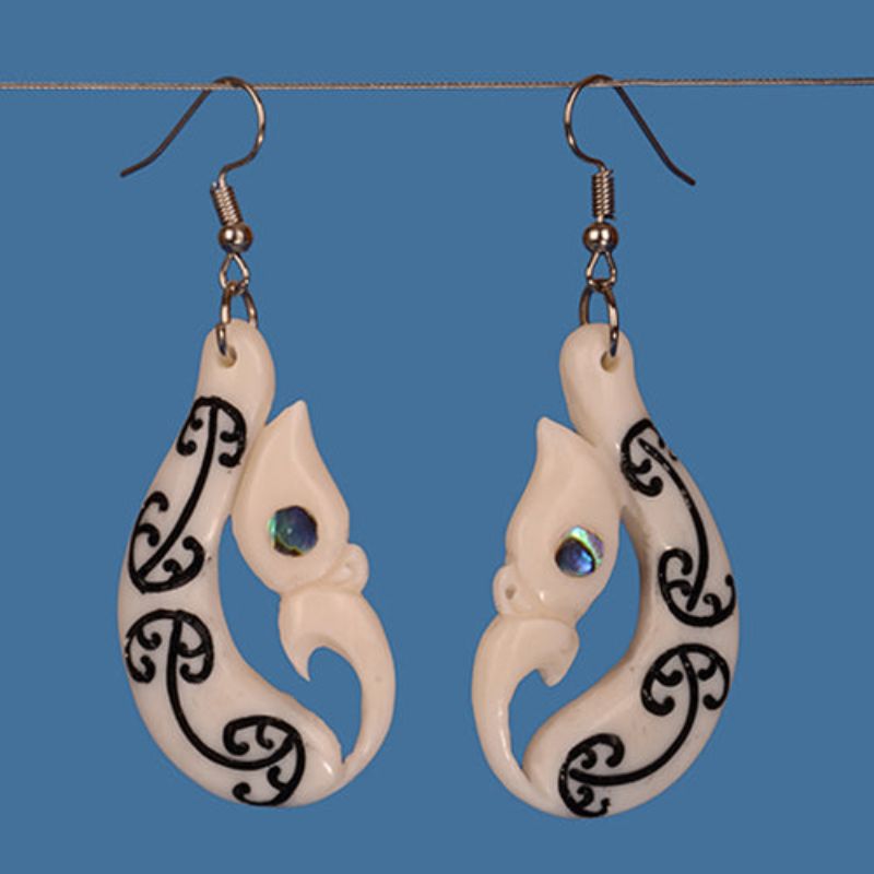 Handcrafted Manaia Earrings in black stained beef bone with paua eyes, celebrating Maori culture and symbolizing protection.