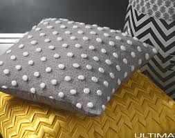 Stylish Charley Dove square cushion in soft neutral color, perfect for enhancing comfort and decor in any space.