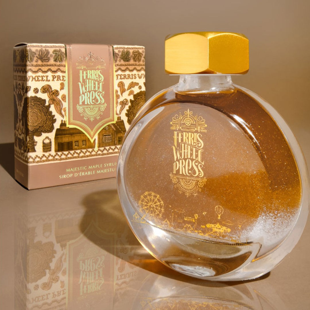 A 38ml bottle of Ferris Wheel Press ink in Majestic Maple Syrup, featuring warm wood tones with a subtle champagne shimmer.