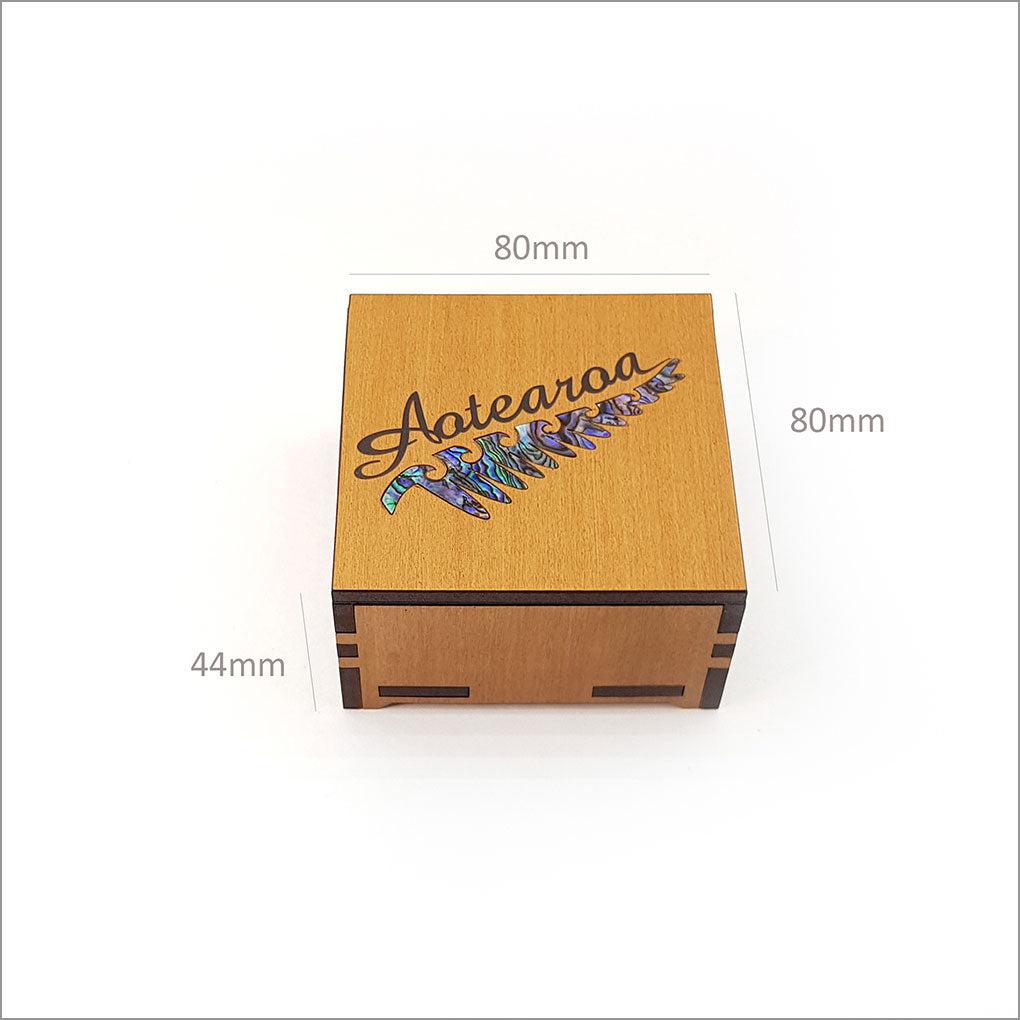 Small trinket box featuring NZ Silver Beech veneer, Rimu design, and iridescent Paua inlay, perfect for storing keepsakes.