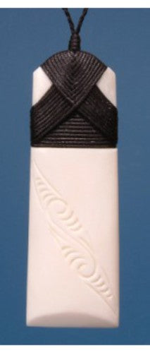 Engraved large toki pendant in bone, symbolizing strength and peace, on adjustable cord, packaged in flax kete.