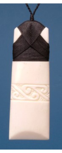 Large engraved Toki pendant made of ethically sourced bone, symbolizing strength, with adjustable black wax cord for personalized wear.