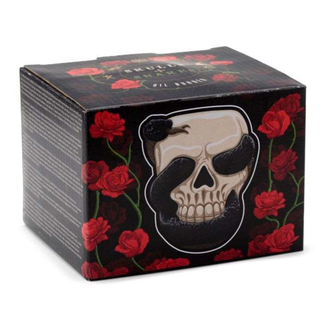 Ceramic skull oil burner with coiled snake design, perfect for aromatherapy and gothic decor, 13cm tall.