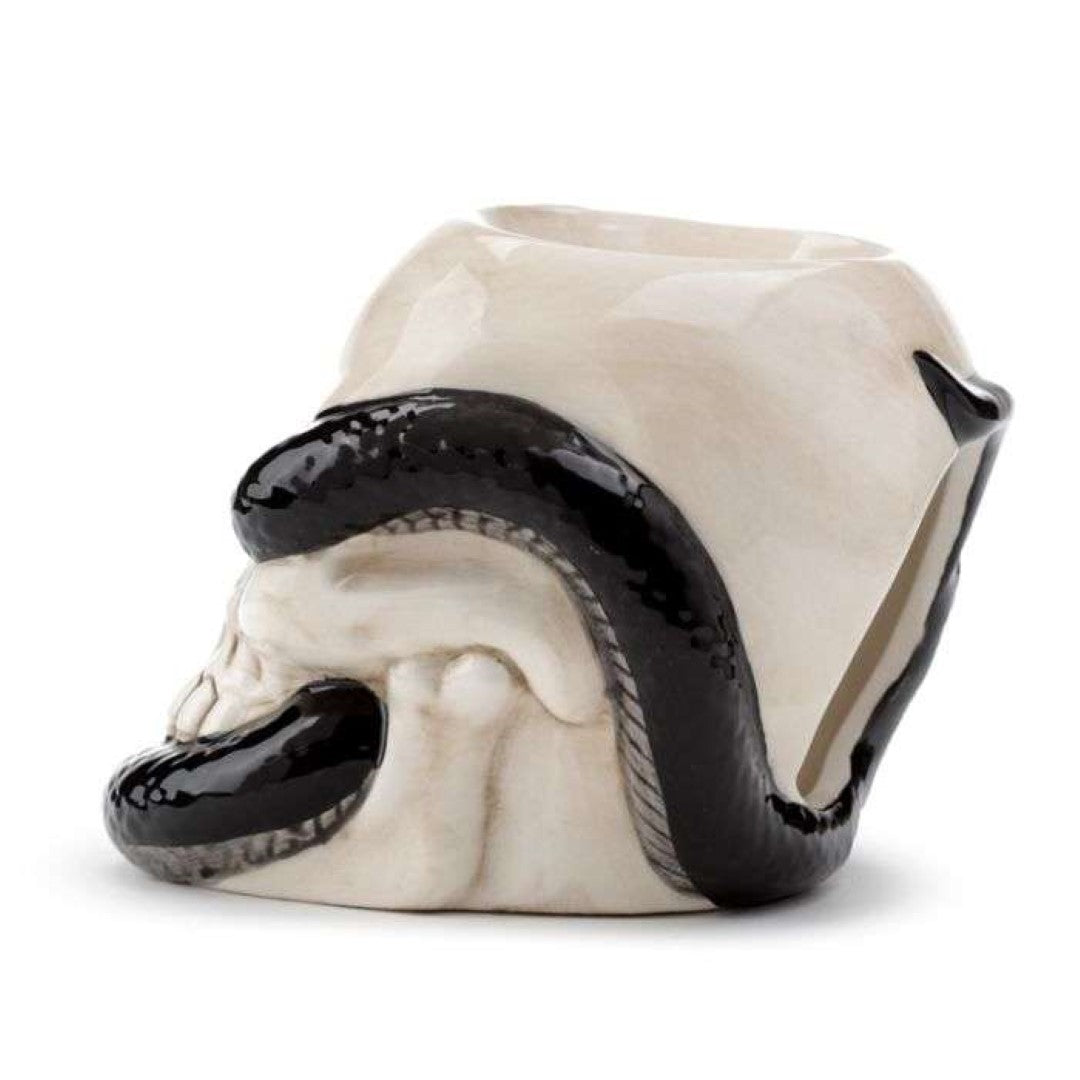 Ceramic oil burner shaped like a skull entwined with a snake, perfect for aromatic oils and stylish home decor.