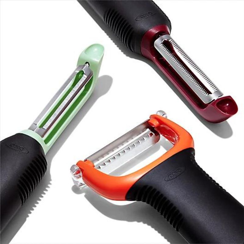 Three OXO Good Grips peelers: swivel, serrated, and julienne, with ergonomic handles and sharp stainless steel blades.
