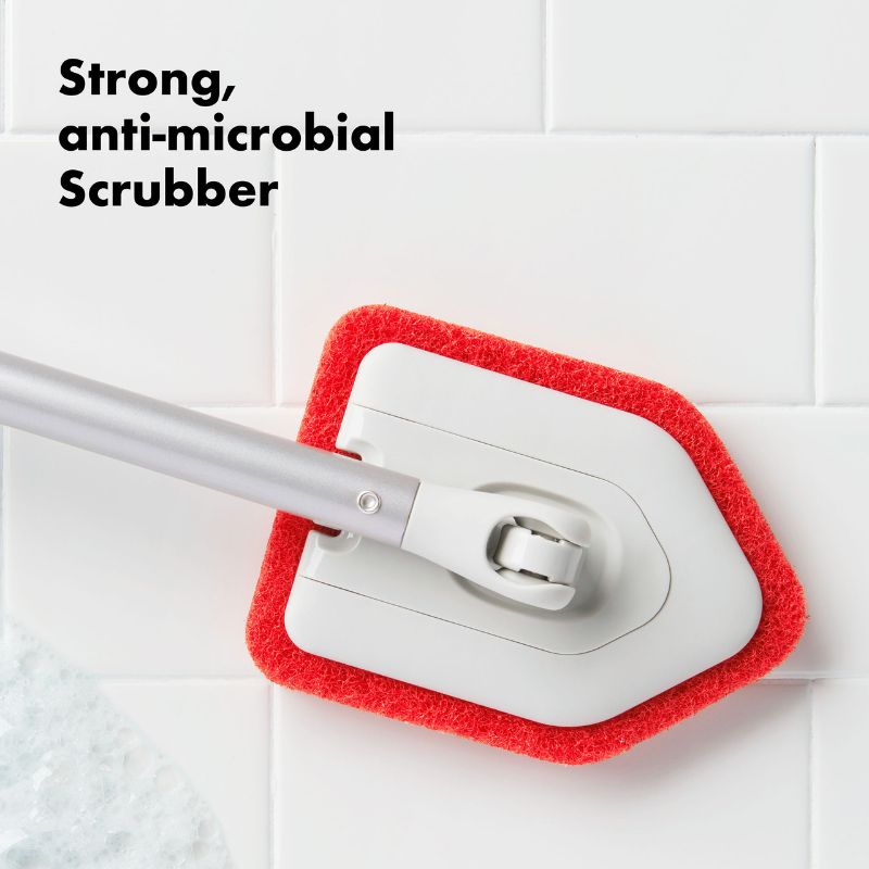OXO Extendable Tub & Tile Scrubber with adjustable reach, anti-microbial pivoting head for deep cleaning and comfort grip.