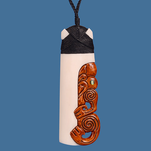 Intricate Bone Toki Pendant featuring a stained Tiki, symbolizing strength and ancestry on an adjustable black wax cord.