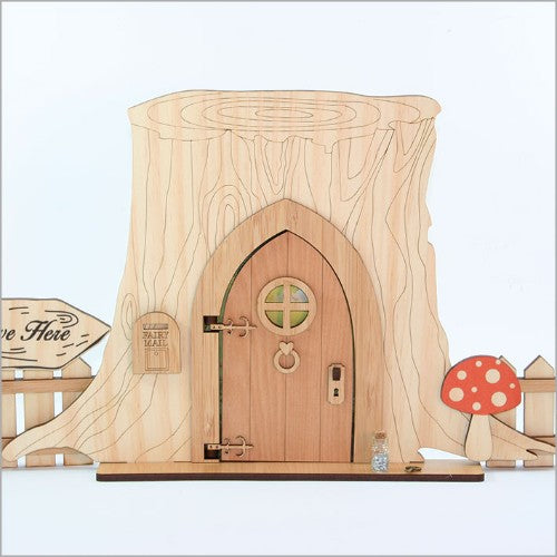Enchanting fairy door kit featuring a tree trunk base, decorative mailbox, fences, and a magical key for creative fun.