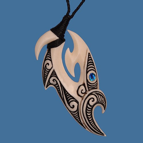 Handcrafted M?ori necklace featuring a bone carving Manaia hook with vibrant P?ua shell eye on an adjustable black cord.