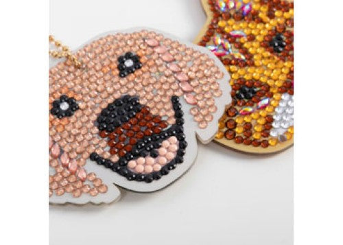 Colorful CrystalArt keyring kit featuring three pet designs, vibrant crystals, and tools for DIY keychain crafting.