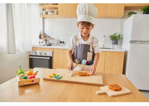 Wooden PlanToys Chef Set for kids, featuring utensils, pots, and ingredients to inspire creative culinary play.