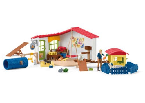Colorful Schleich Pet Hotel playset with cozy rooms and outdoor spaces for imaginative pet care role-playing.