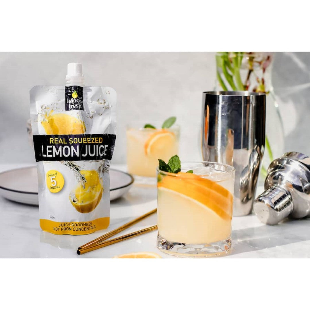 Clear bottle of Lemon Fresh Squeezed Fruit Juice showcasing 100% real lemon juice, ideal for cooking, baking, and beverages.
