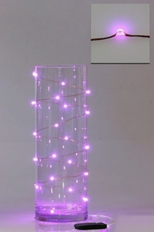 Light pink LED seed lights on copper wire, perfect for enhancing decor and creating a warm ambiance in any space.