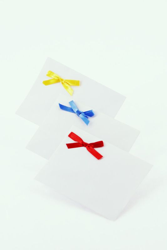 Colorful Fiesta envelopes with attached bows, ideal for gifting cards and cash, 85x110mm, 400 per box.