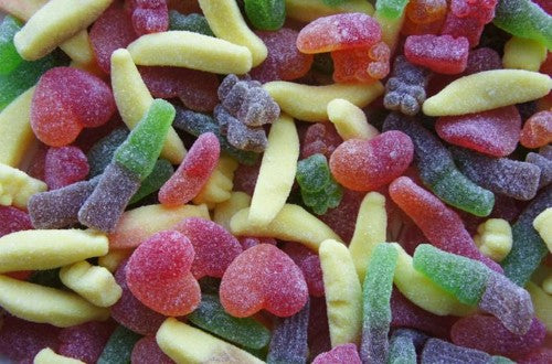 Colorful 2kg bag of Damel Sugar Assorted Lollies featuring gummy bears, hearts, bananas, and fizzy cola bottles.