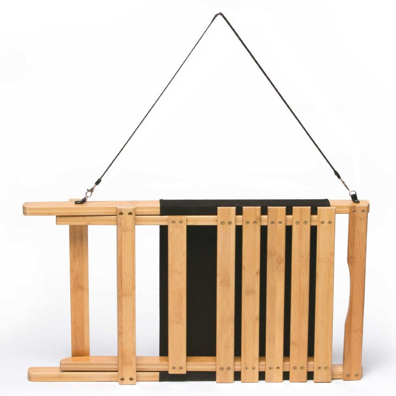 Lightweight and foldable Wave Beach Chair in sustainable bamboo with black canvas backrest, perfect for outdoor relaxation.