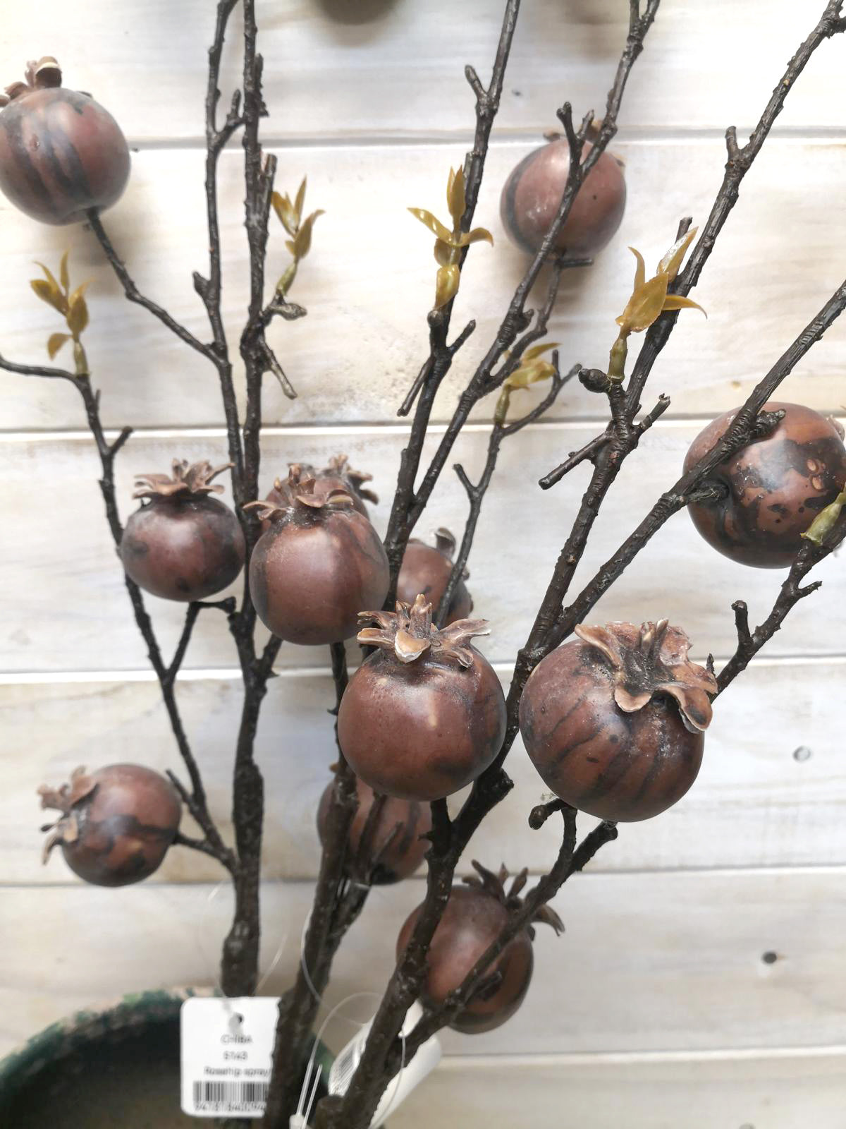 Vibrant artificial large rosehip spray adding elegance and warmth to home decor, ideal for year-round use and no upkeep.