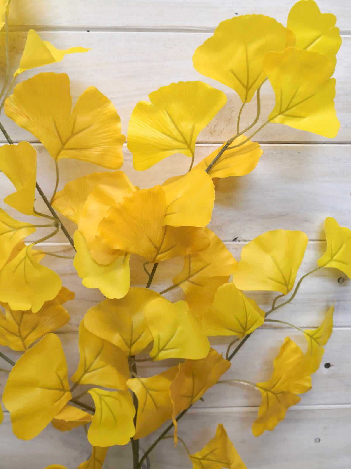 Set of 4 artificial golden ginkgo leaf sprays, vibrant and lifelike, ideal for enhancing home decor and arrangements.