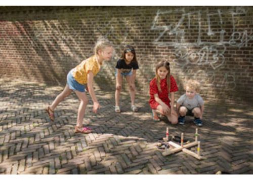 Colorful wooden ring toss game, perfect for outdoor fun and enhancing motor skills for all ages.