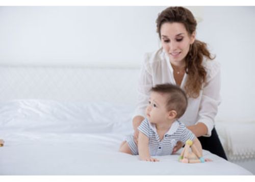 Colorful triangle-shaped clutching toy made from eco-friendly materials, designed for sensory play and motor skill development in babies.