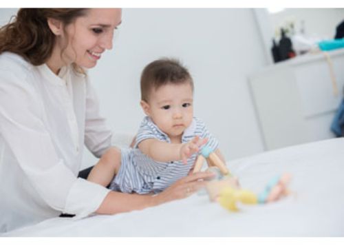 Colorful triangle-shaped clutching toy made from eco-friendly materials, perfect for infants' sensory exploration and motor skill development.