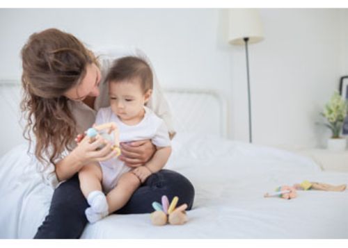 Colorful triangle shaped clutching toy made of eco-friendly rubberwood, promoting sensory exploration and fine motor skills in infants.
