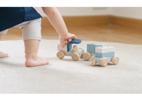 Colorful eco-friendly wooden stacking train set for toddlers, promoting fine motor skills and imaginative play.