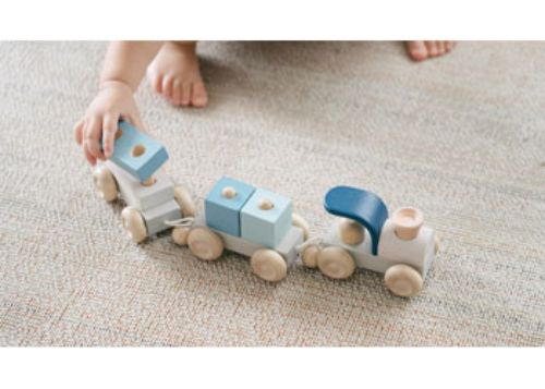 Colorful wooden stacking train set for toddlers, promoting fine motor skills and imaginative play with eco-friendly materials.