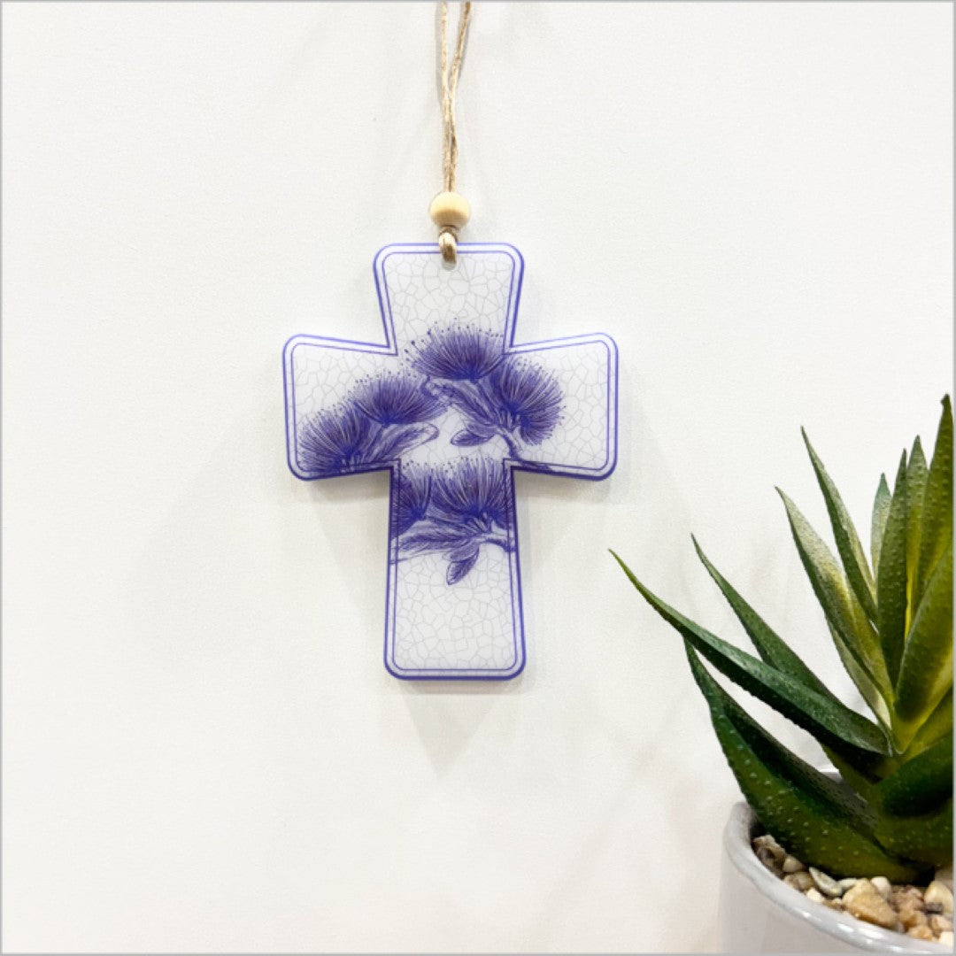 Hanging ornament featuring a Pohutukawa cross, crafted from vibrant satin acrylic with intricate laser-cut details.