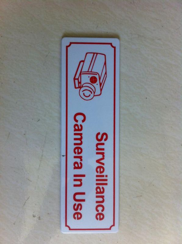 Set of 12 plastic signs indicating surveillance camera usage for enhanced security awareness.