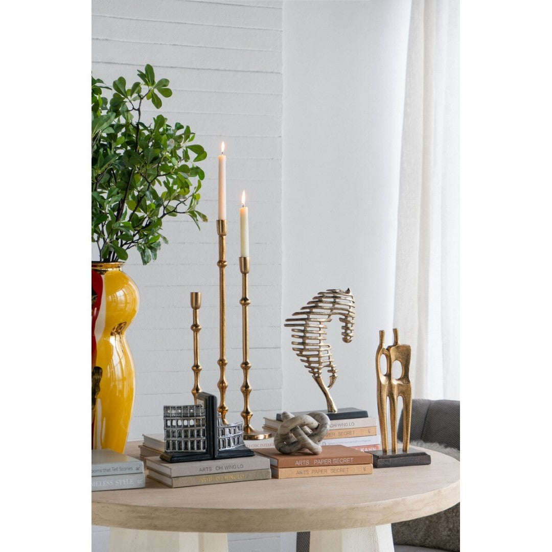 Gold aluminum taper candle holder, 11.4 x 11.4 x 39.4 cm, adds elegance and warmth to any decor.