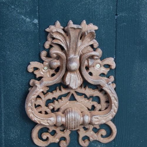 Classic cast iron door knocker with a decorative design, measuring 13 x 3 x 20cm, perfect for enhancing home entrances.
