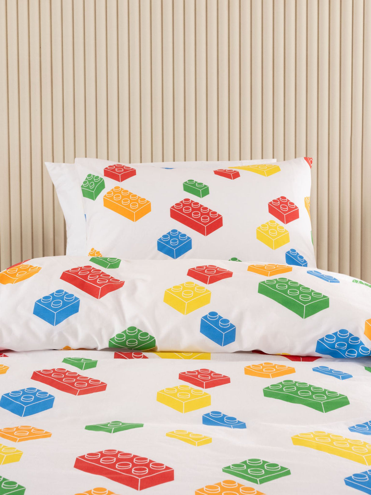 Colorful building blocks on a white backdrop create a playful duvet cover set for children's bedrooms.