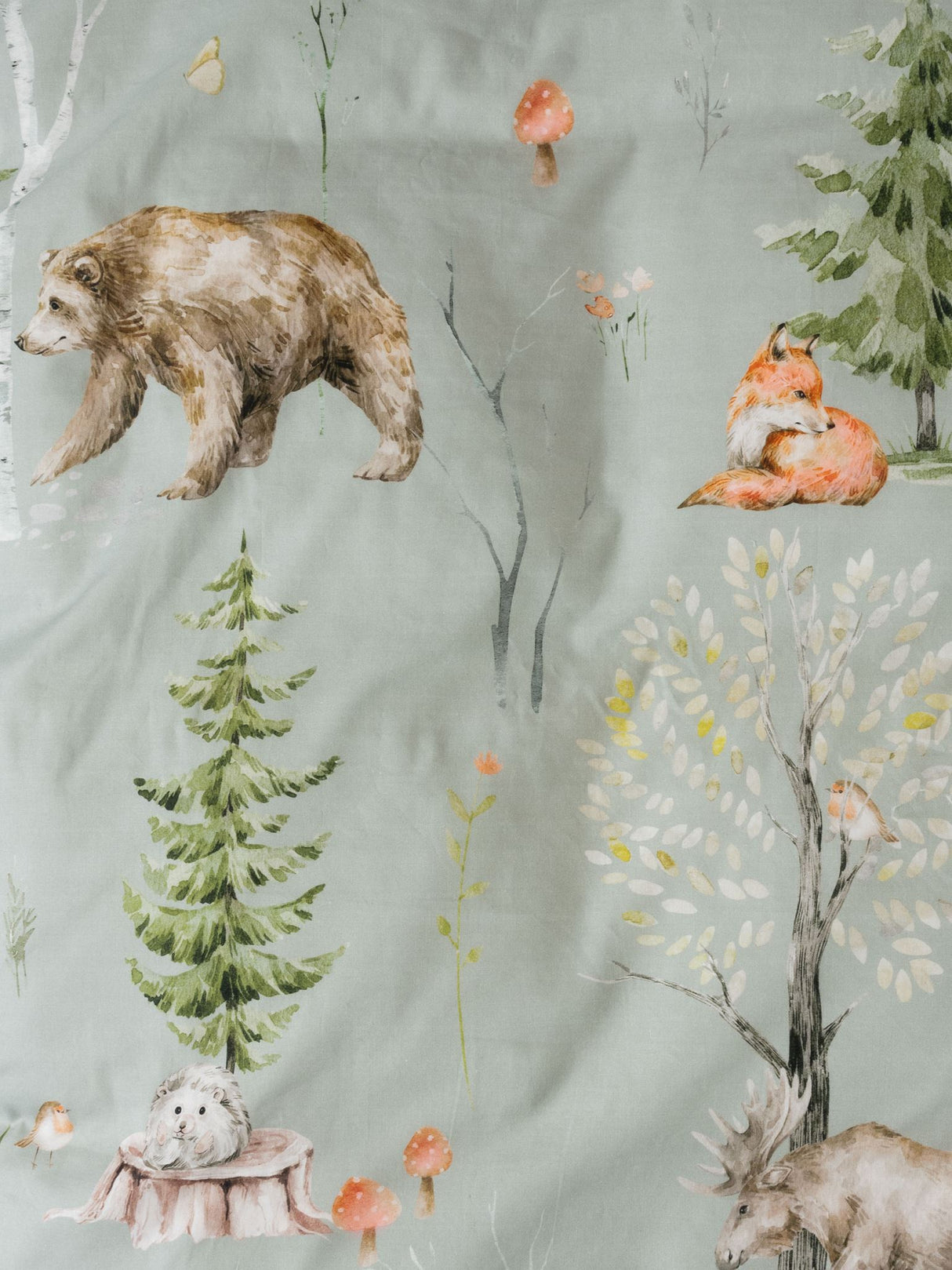 Single duvet cover set featuring whimsical woodland animals in a sage green hue, promoting calming sleep for children.
