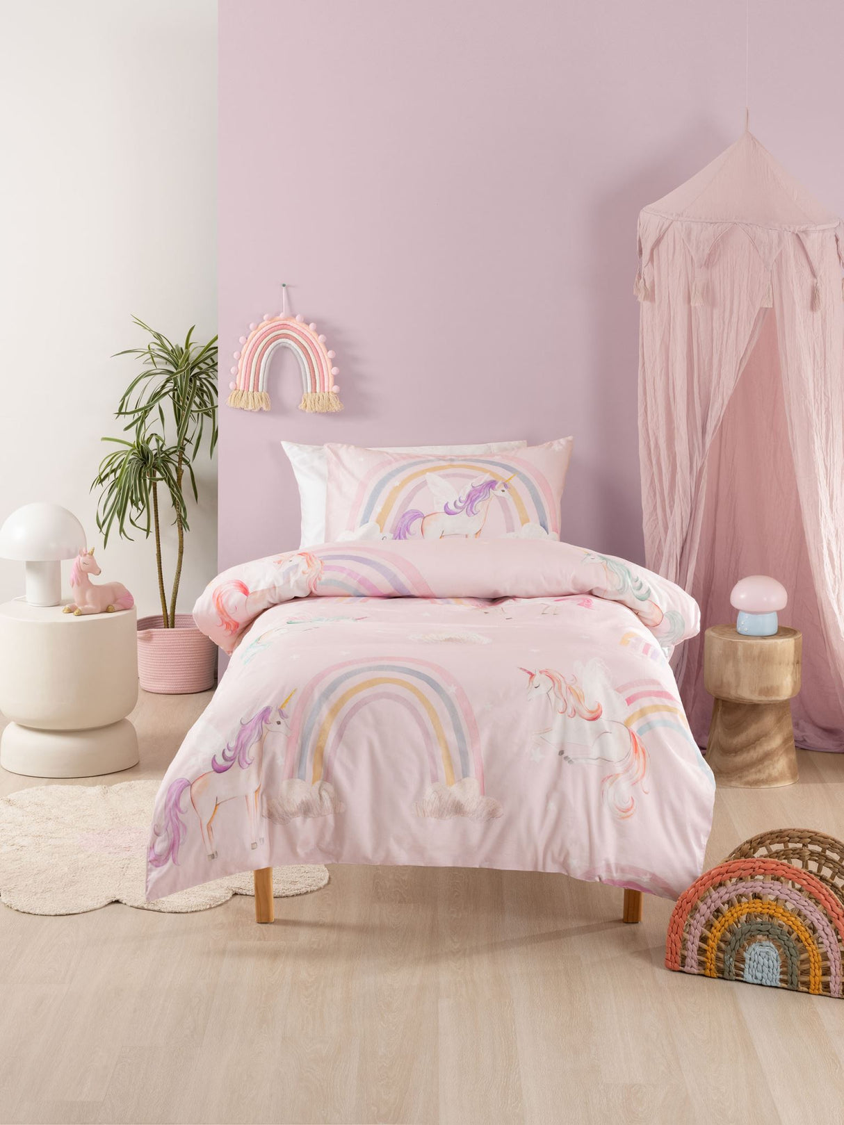 Single Duvet Cover Set featuring whimsical unicorns and rainbows on a soft pink background, made from 100% cotton.