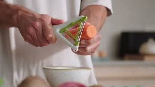 Joseph Joseph Switch 2in1 Peeler featuring ergonomic design, stainless-steel blades, and a potato-eye remover for versatile peeling.