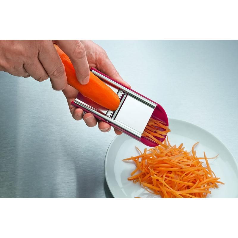 Victorinox Handslicer featuring a red ergonomic handle and three stainless steel attachments for slicing, julienne, and grating.