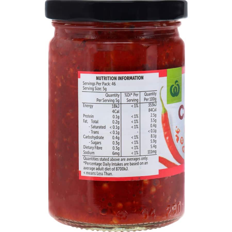 A jar of Woolworths Crushed Chilli showcasing natural chili flakes that add robust heat to various dishes.