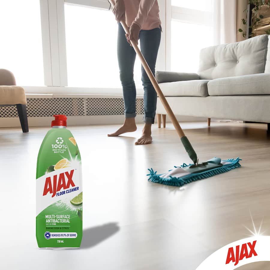 Ajax Floor Cleaner in a 100% recycled bottle, featuring baking soda for powerful, eco-friendly cleaning of stone surfaces.
